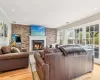 Living room with crown molding, a fireplace, and vaulted ceiling