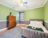 Bathroom featuring hardwood / wood-style floors, a shower with door, and crown molding