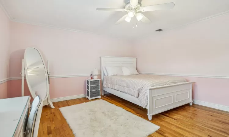 Bedroom featuring ceiling fan, a closet, and ornamental molding