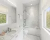 Full bathroom with tile patterned flooring, vanity, toilet, and tiled shower / bath combo