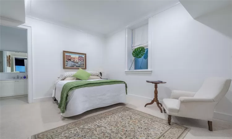 Bedroom with light colored carpet and ornamental molding