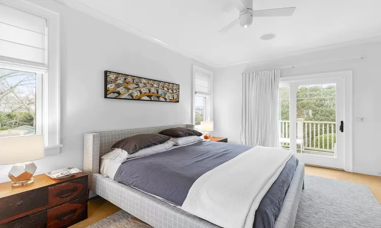 Bedroom with access to exterior, wood-type flooring, ceiling fan, and ornamental molding