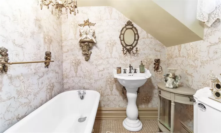 Bathroom featuring a bathtub and toilet