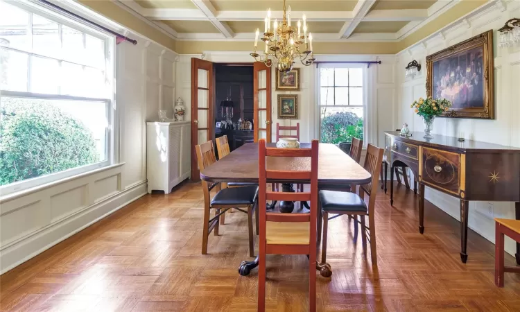 Dining room featuring a chandelier, beam ceiling, and coffered ceiling