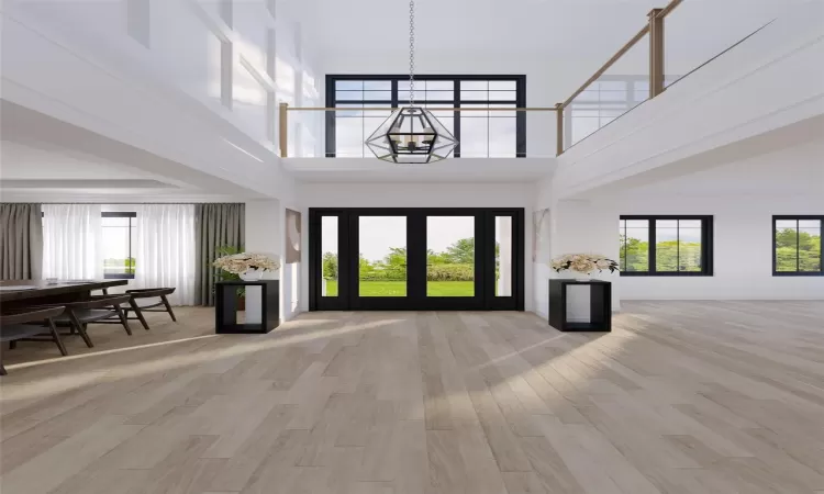 Rendering - Foyer entrance featuring a notable chandelier, light wood-type flooring, and a high ceiling