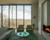 Living room with a multi sided fireplace and light hardwood / wood-style flooring