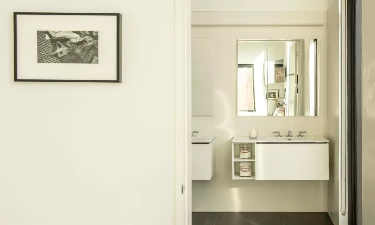 Bathroom with tile patterned floors and vanity