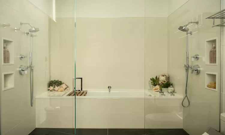 Bathroom featuring tile patterned floors and plus walk in shower