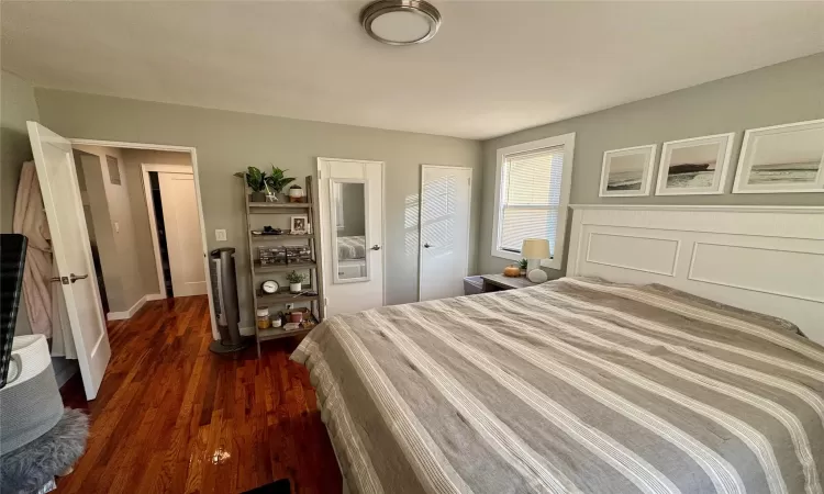 Bedroom with dark hardwood / wood-style floors