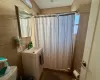 Bathroom with washer / clothes dryer, toilet, and sink