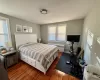 Bedroom with dark wood-type flooring and radiator