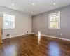 Empty room with dark hardwood / wood-style flooring