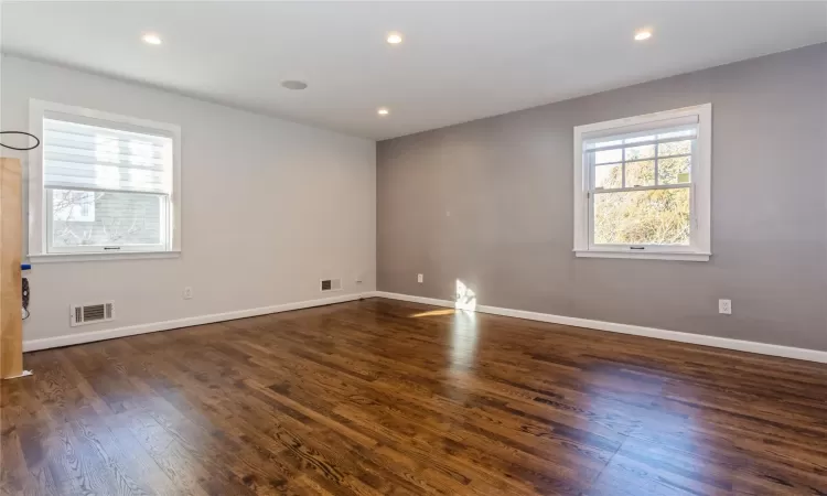 Empty room with dark hardwood / wood-style flooring