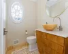 Bathroom featuring toilet, vanity, tile patterned floors, and crown molding