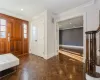 Entrance foyer featuring dark parquet flooring and crown molding