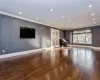 Unfurnished living room featuring french doors, dark wood-type flooring, and crown molding