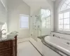 Full bathroom with plus walk in shower, tile patterned flooring, lofted ceiling, toilet, and vanity