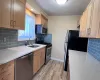 Kitchen featuring light stone countertops, sink, stainless steel appliances, tasteful backsplash, and crown molding