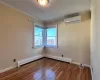 Bedroom 2 featuring an AC wall unit, dark hardwood / wood-style flooring, a baseboard heating unit, and ornamental molding