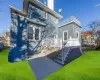 Rear view of house featuring a yard and a deck