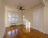 Spare room with ceiling fan, radiator heating unit, and hardwood / wood-style flooring