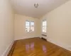 Empty room featuring radiator and wood-type flooring