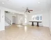 Unfurnished living room featuring ceiling fan