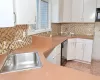 Kitchen featuring white cabinets, dishwasher, and sink