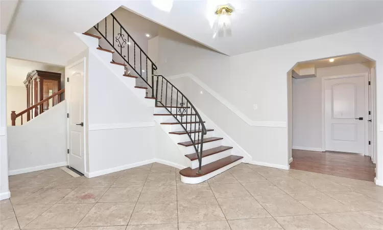 Stairs featuring tile patterned floors