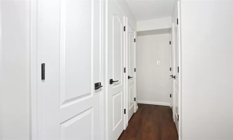 Hall with dark hardwood / wood-style floors