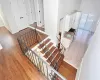 Staircase featuring sink and hardwood / wood-style flooring