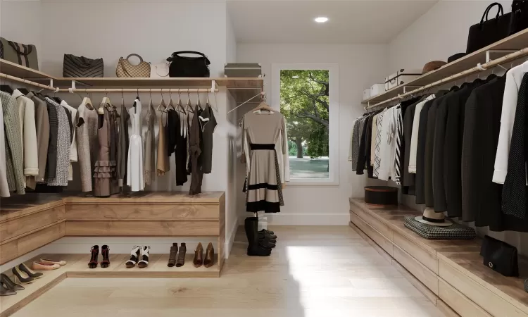 Walk in closet with light wood-type flooring