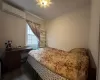 Bedroom featuring dark hardwood / wood-style floors and an AC wall unit