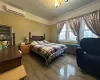 Bedroom featuring a wall mounted air conditioner, wood-type flooring, and radiator