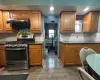 Kitchen featuring dark hardwood / wood-style flooring, gas stove, and tasteful backsplash