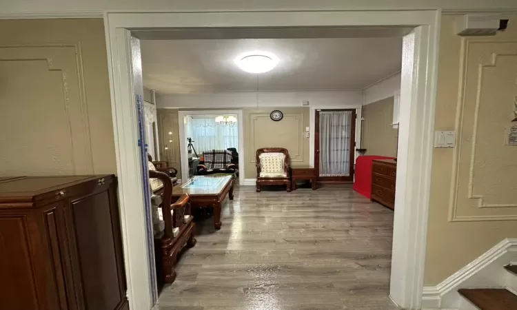 Hall featuring a chandelier and light hardwood / wood-style flooring