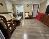 Living room featuring light hardwood / wood-style floors and a notable chandelier