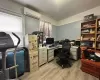 Home office with a wall unit AC and light hardwood / wood-style floors