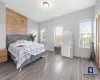 Bedroom with radiator heating unit and hardwood / wood-style floors