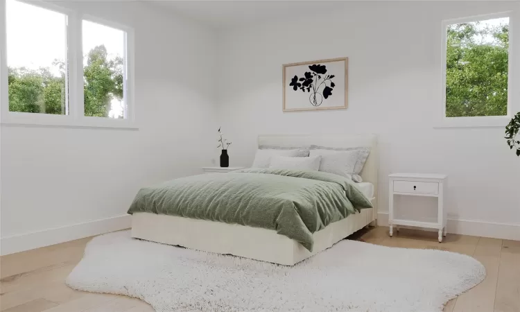 Bedroom featuring hardwood / wood-style flooring and multiple windows