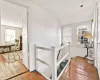 Staircase with hardwood / wood-style flooring and vaulted ceiling