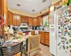 Kitchen with white appliances and light tile patterned flooring