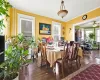 Dining room featuring ceiling fan, crown molding, and dark wood-type flooring