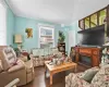 Living room with plenty of natural light, dark hardwood / wood-style floors, and ornamental molding