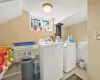 Laundry room with light tile patterned floors and washing machine and clothes dryer