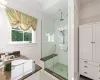 Bathroom featuring crown molding, vanity, and an enclosed shower