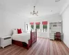 Bedroom with carpet, crown molding, and an inviting chandelier