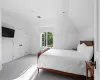 Carpeted bedroom with a closet and lofted ceiling