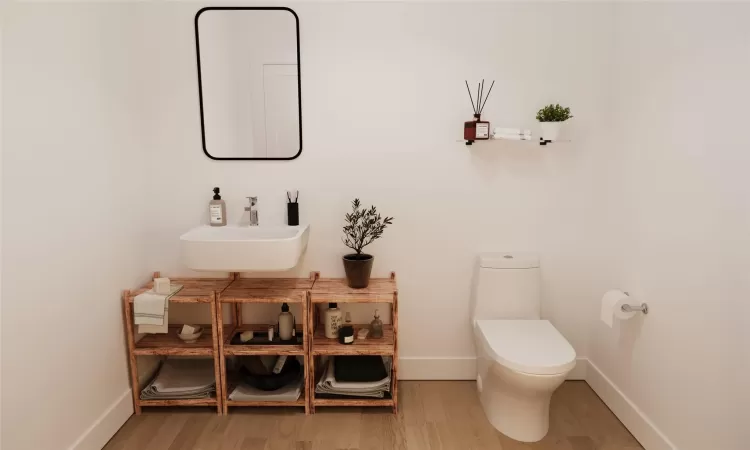 Bathroom featuring hardwood / wood-style floors, toilet, and sink