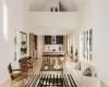 Living room with a high ceiling and light hardwood / wood-style flooring